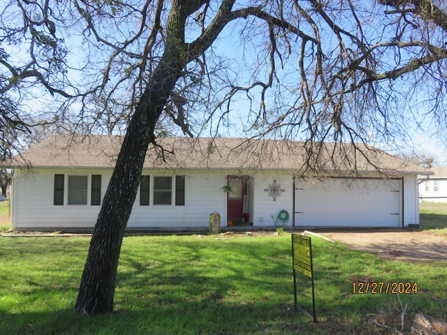 single story home with a garage and a front lawn