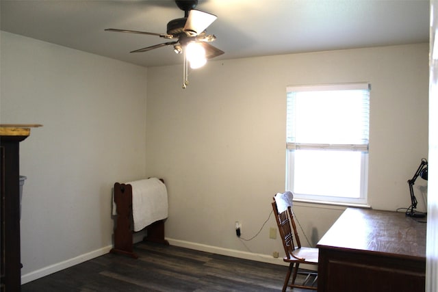 unfurnished office with ceiling fan and dark hardwood / wood-style flooring