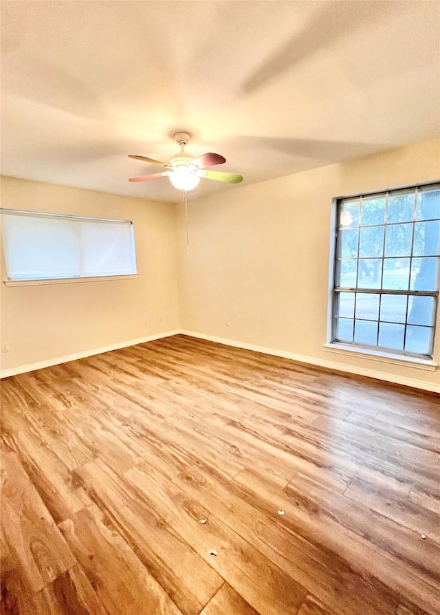 spare room with hardwood / wood-style floors and ceiling fan