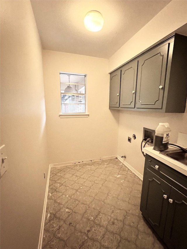 clothes washing area featuring cabinets, hookup for a washing machine, electric dryer hookup, sink, and hookup for a gas dryer