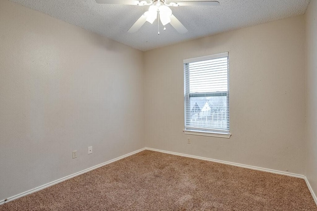 carpeted empty room with a textured ceiling and ceiling fan