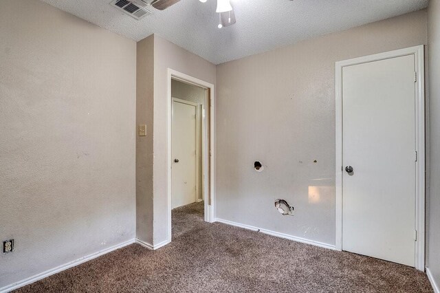 interior space with ceiling fan, carpet floors, and a textured ceiling