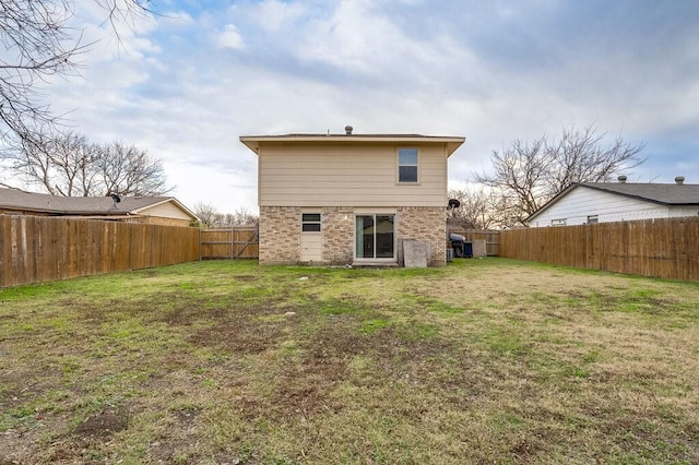 rear view of property featuring a yard