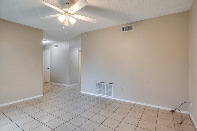 tiled spare room with ceiling fan and a textured ceiling