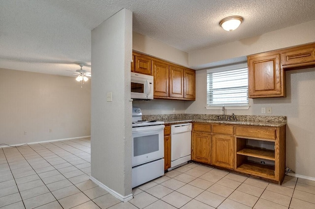 kitchen with ceiling fan, sink, light stone countertops, white appliances, and light tile patterned floors