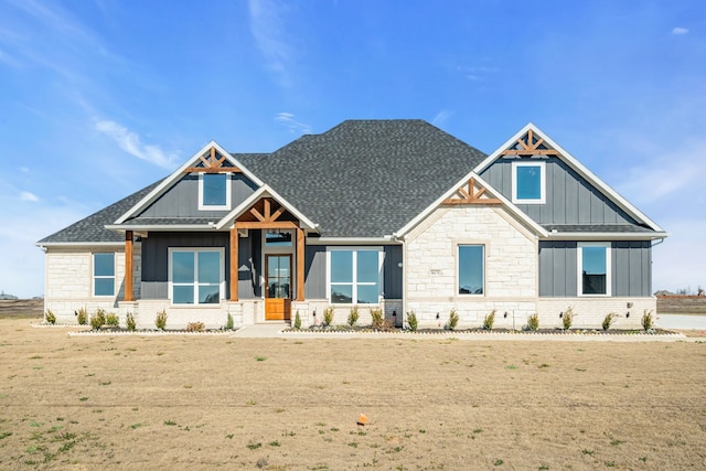 craftsman-style home with roof with shingles and board and batten siding