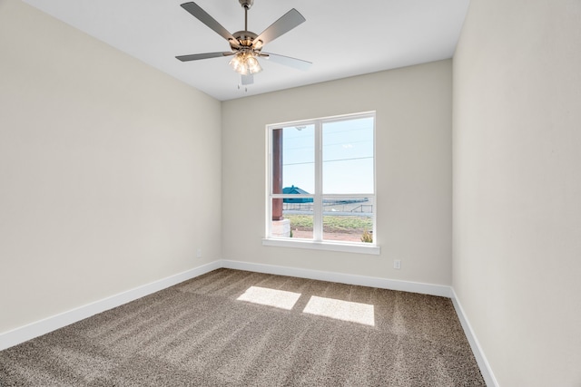 spare room with a ceiling fan, carpet flooring, and baseboards