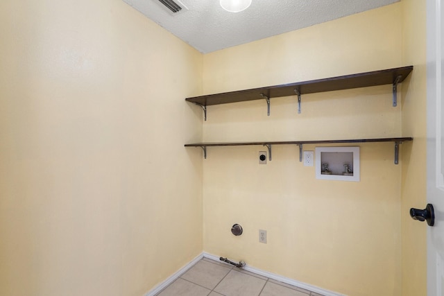 laundry room with washer hookup, a textured ceiling, electric dryer hookup, light tile patterned floors, and hookup for a gas dryer