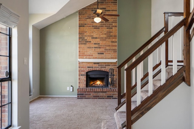 carpeted living room featuring ceiling fan and a fireplace