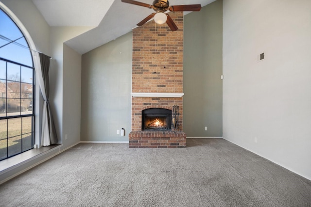 unfurnished living room with carpet, ceiling fan, a brick fireplace, and vaulted ceiling