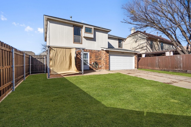 rear view of house with a yard and a garage