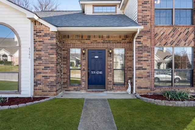 property entrance featuring a lawn