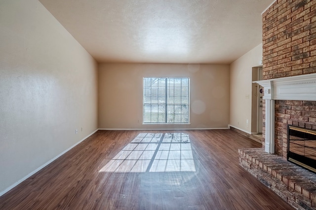 unfurnished living room featuring a fireplace and dark hardwood / wood-style floors