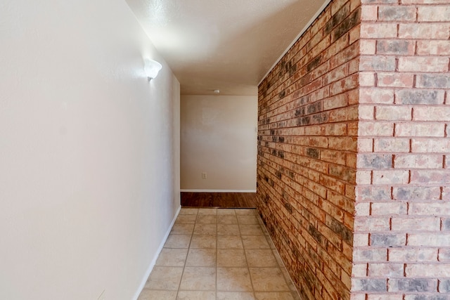 hallway featuring brick wall