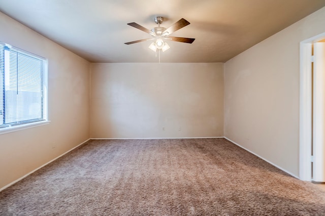 carpeted empty room featuring ceiling fan