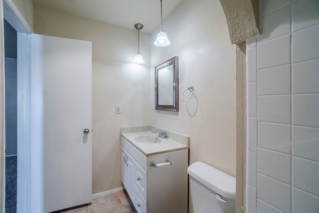 bathroom featuring tile patterned floors, vanity, and toilet