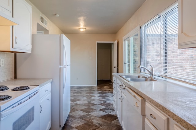 kitchen with white cabinets, white appliances, and sink