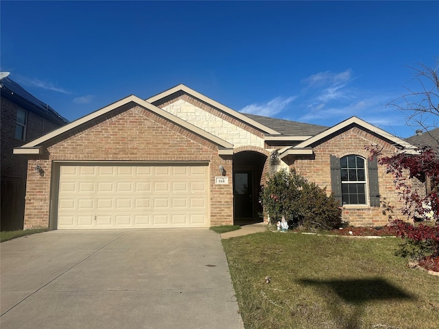 view of front of home with a garage and a front lawn