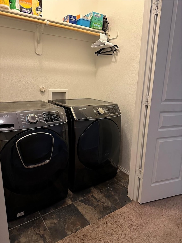 clothes washing area with independent washer and dryer and dark carpet