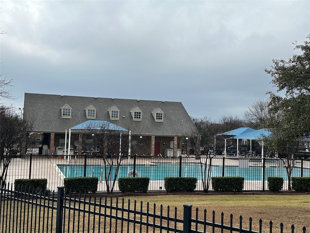 view of pool with a lawn