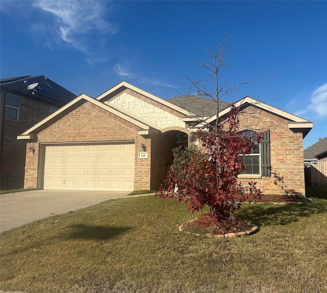 view of front of property with a garage and a front lawn