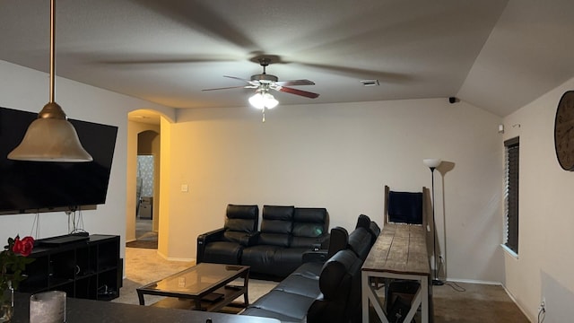 living room with ceiling fan, lofted ceiling, and carpet flooring