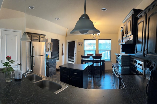 kitchen featuring exhaust hood, sink, vaulted ceiling, decorative light fixtures, and stainless steel appliances