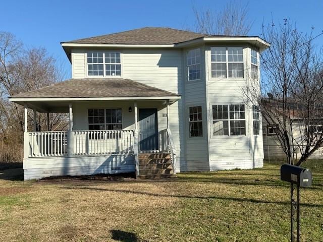 view of front of property with a porch and a front lawn