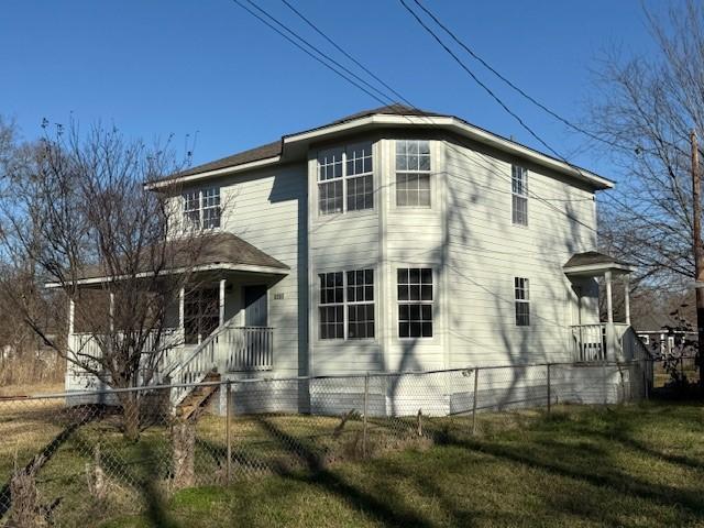 view of side of home featuring a lawn