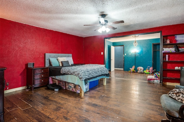 bedroom featuring a textured ceiling, ceiling fan, and dark hardwood / wood-style floors