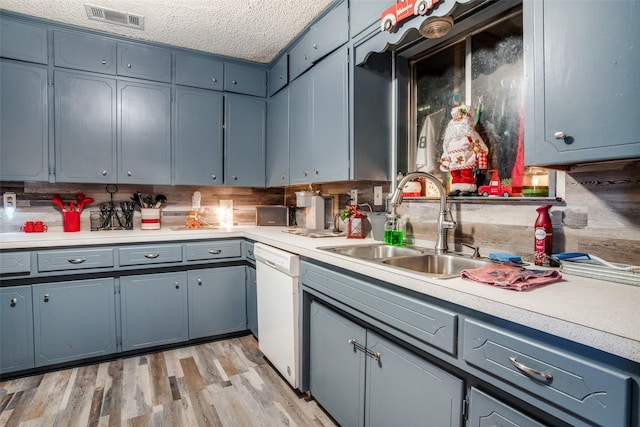 kitchen with backsplash, a textured ceiling, sink, light hardwood / wood-style flooring, and dishwasher