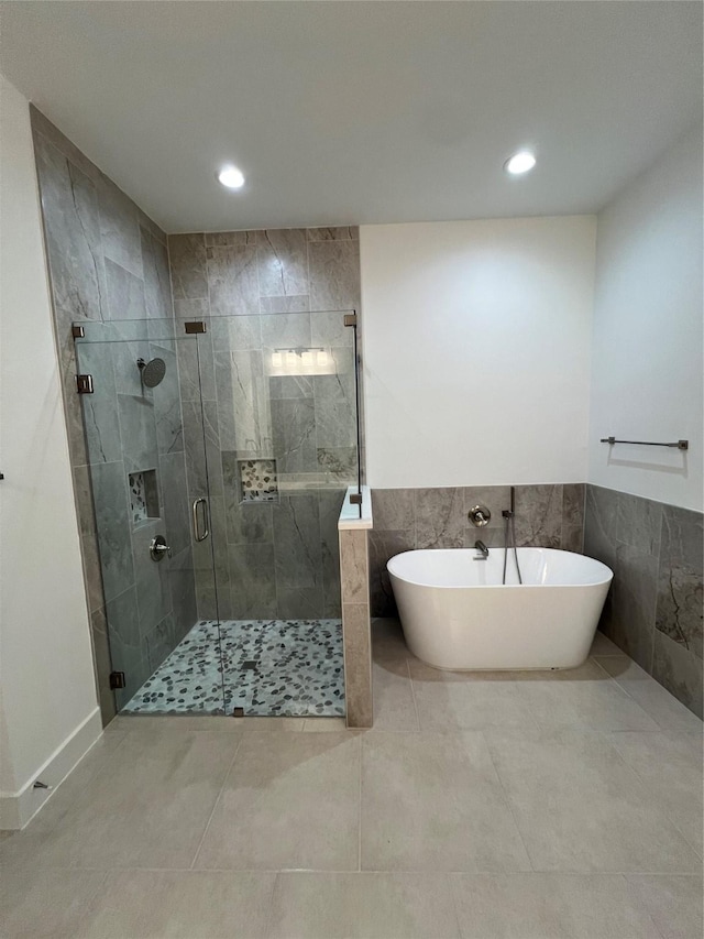 bathroom featuring tile patterned floors and separate shower and tub