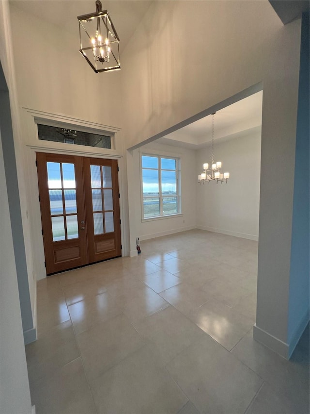 foyer entrance with french doors and a notable chandelier