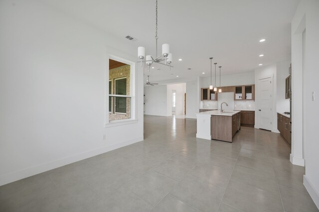 571 N Armstrong Rd, Venus, TX 76084 - kitchen featuring visible vents, open floor plan, an island with sink, light countertops, and backsplash