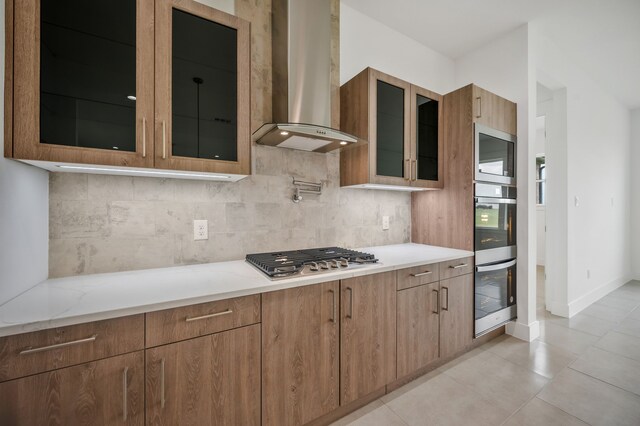 571 N Armstrong Rd, Venus, TX 76084 - kitchen with decorative backsplash, appliances with stainless steel finishes, wall chimney range hood, and glass insert cabinets