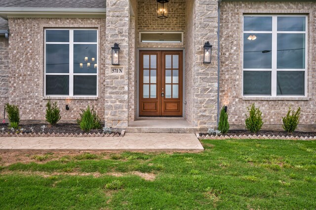 571 N Armstrong Rd, Venus, TX 76084 - view of exterior entry with a lawn and brick siding