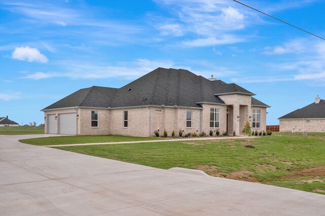 571 N Armstrong Rd, Venus, TX 76084 - exterior space with a front yard, roof with shingles, brick siding, concrete driveway, and an attached garage