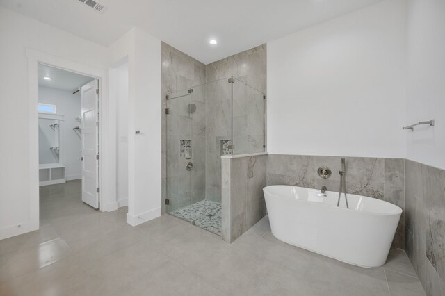 571 N Armstrong Rd, Venus, TX 76084 - full bathroom featuring tile walls, a freestanding tub, visible vents, and a stall shower