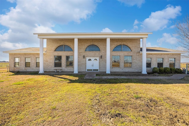 greek revival inspired property with a front yard and french doors