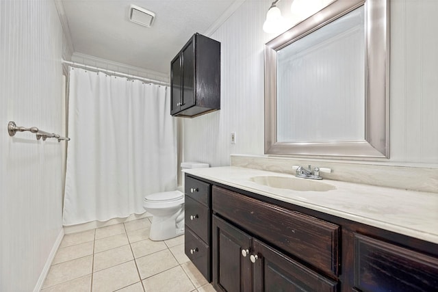 bathroom with tile patterned floors, toilet, vanity, and ornamental molding