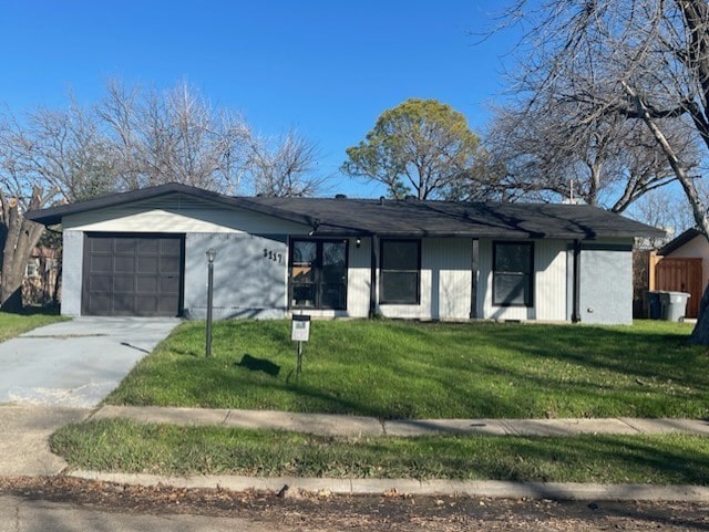 ranch-style house featuring a garage and a front lawn