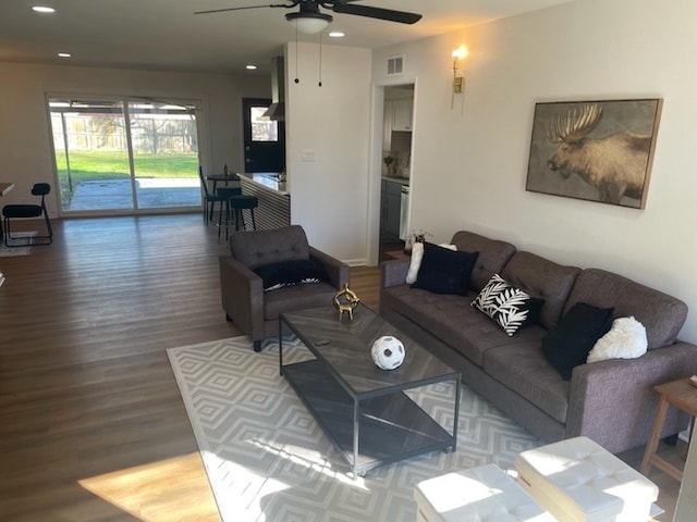 living room with hardwood / wood-style floors and ceiling fan