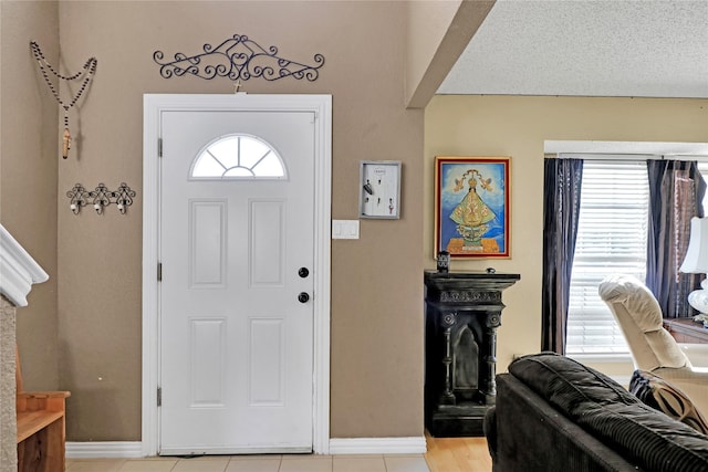 tiled entrance foyer with plenty of natural light and a textured ceiling