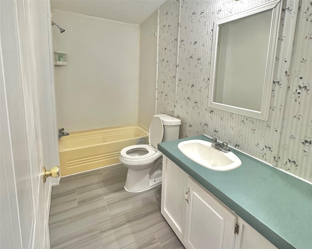 full bathroom featuring vanity, toilet, a textured ceiling, and bathtub / shower combination