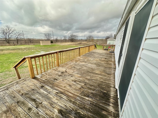 wooden terrace with a yard