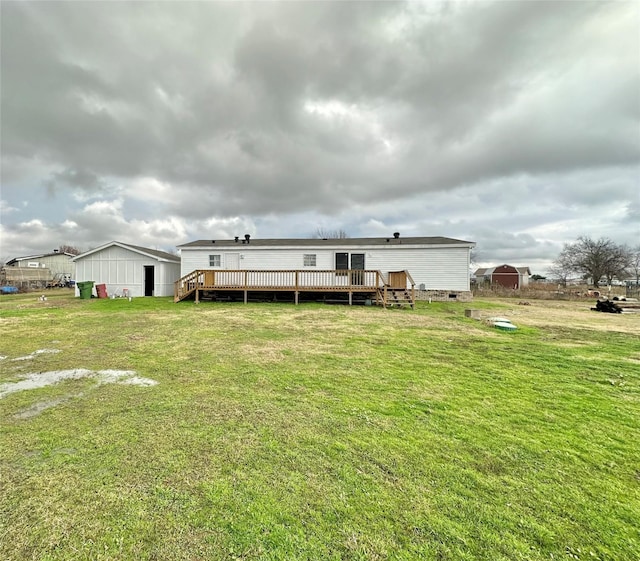 back of property with a lawn and a deck