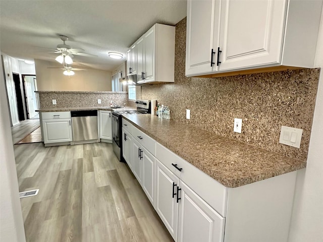 kitchen with white cabinets, appliances with stainless steel finishes, tasteful backsplash, and ceiling fan