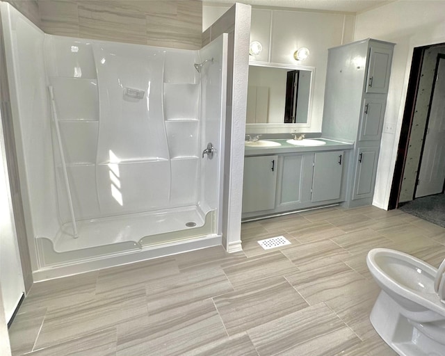 bathroom featuring vanity, a bidet, and walk in shower