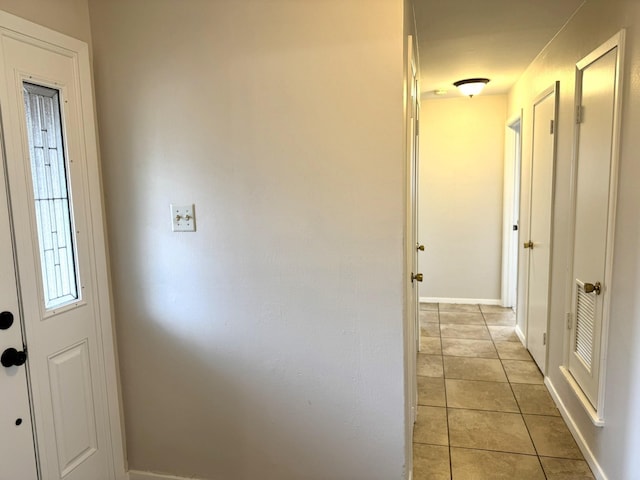 hallway featuring light tile patterned floors