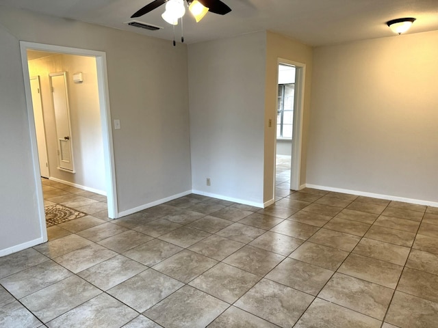 unfurnished room with ceiling fan and light tile patterned flooring